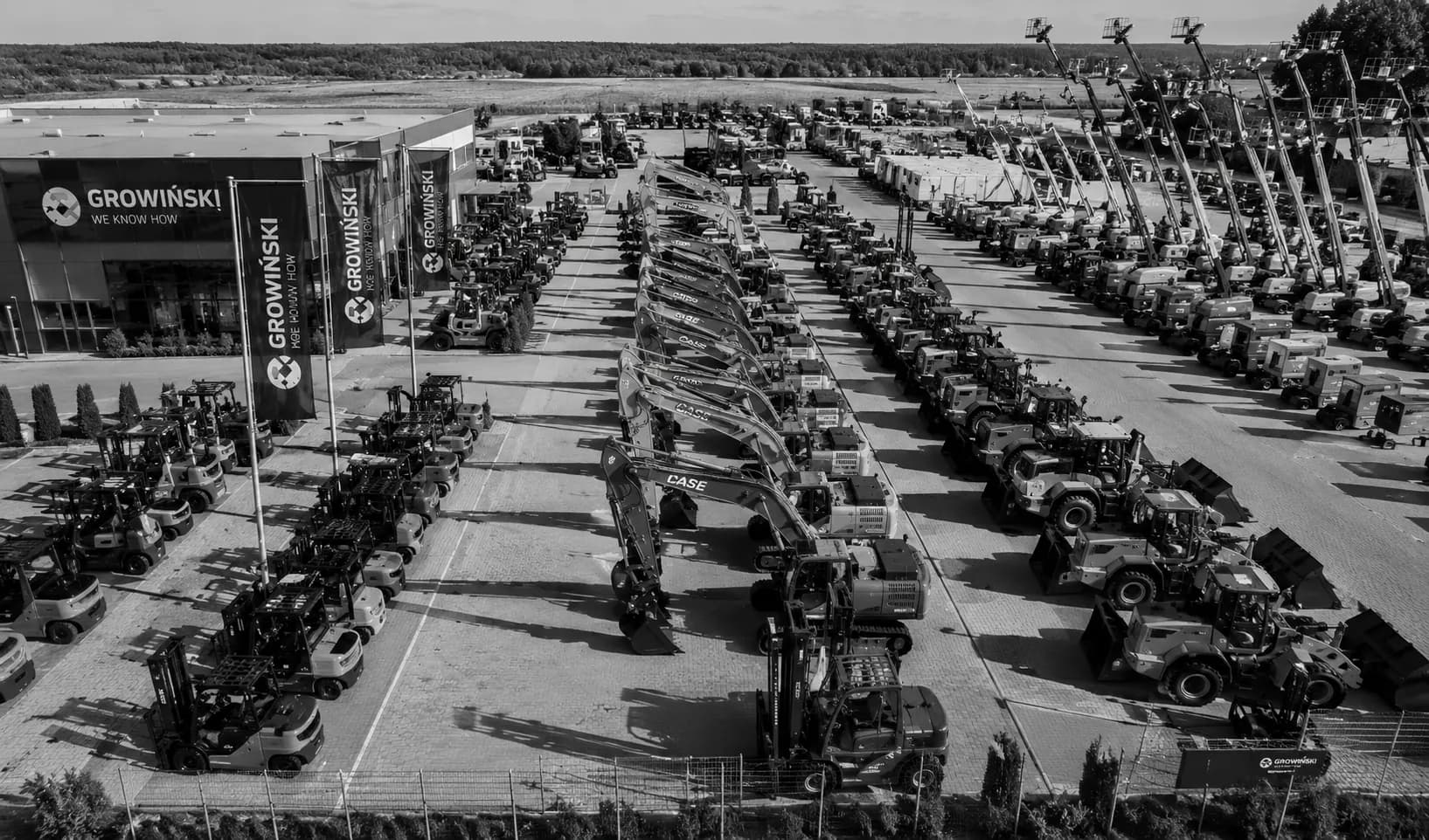 Dealer machinery yard seen from above, rows of units awaiting sale